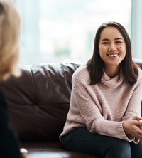 A happy woman smiling and agreeing with her counselor during Peoria Counseling Services