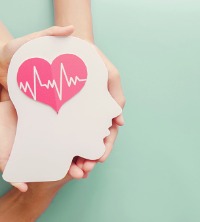 Hands holding an image of a head with a heart over the brain, representing mental health therapy and counselors near you