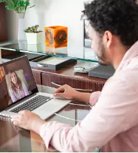 A man talking with their Therapist in Dunlap IL via a computer