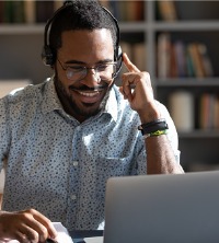 A happy man talking with their therapist on the computer during Telehealth Counseling in Washington IL