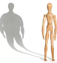 An image of a skinny person with a large shadow, how someone might think of their body when suffering from anorexia