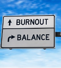 A road sign pointing to burnout and also leading to "balance" for Burnout Treatment in Peoria IL