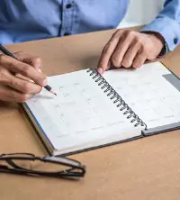 A man planning their schedule for the summer