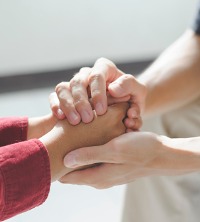 Counselors in East Peoria IL holding the hands of their client