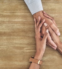 Counselor holding the hand of a client to give support during Depression Therapy in Peoria IL