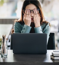 A woman feeling stressed and anxious at work, needing Anxiety Therapy in East Peoria IL