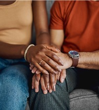 A couple holding hands while in Couples Therapy in East Peoria IL