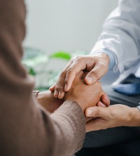 Counselor comforting client by holding their hands during Counseling in East Peoria IL