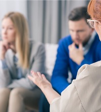 A therapist talking with an unhappy couple during Relationship Counseling in Dunlap IL