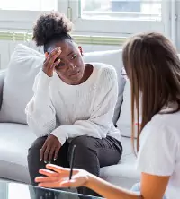 A woman struggling with depression and talking with her therapist, during Depression Counseling in East Peoria IL