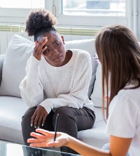 Sad woman talking with counselor during Depression Therapy in Peoria IL