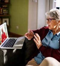 A woman talking with a therapist during telehealth counseling in East Peoria IL