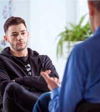 A man talking with a counselor, discussing Anxiety Management in East Peoria IL