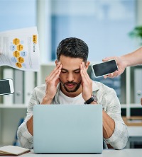 A man contending with burnout at work, needing Burnout Therapy in Dunlap IL