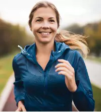 A woman running, using exercise to help improve her mental health and treat depression and anxiety