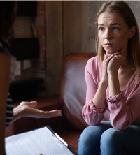 A concerned woman talking with a mental health professional during General Counseling in Dunlap IL