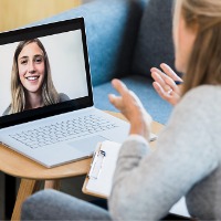 A counselor talking with their client via computer during Peoria Telehealth Counseling