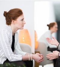 A woman listening to her counselor during Burnout Therapy in East Peoria IL