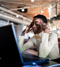 A woman struggling with stress at work, needing help through Burnout Treatment in Washington IL