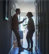 An angry man arguing with their significant other, requiring intervention from a marriage counselor to help resolve the conflict.